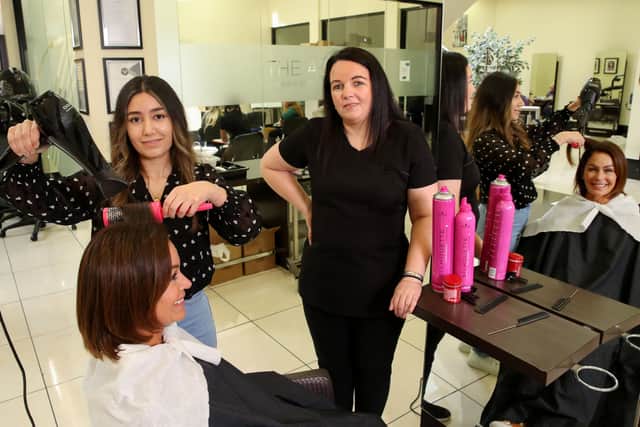 Caroline Kenney (sitting) with Sarah Alou and Wendy Norton, vocational tutor and Portadown Hair and Beauty Academy where Sarah, who fled war-torn Syria, has become the academy's first Kurdish graduate.