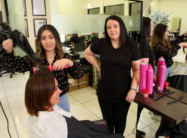 Caroline Kenney (sitting) with Sarah Alou and Wendy Norton, vocational tutor and Portadown Hair and Beauty Academy where Sarah, who fled war-torn Syria, has become the academy's first Kurdish graduate.