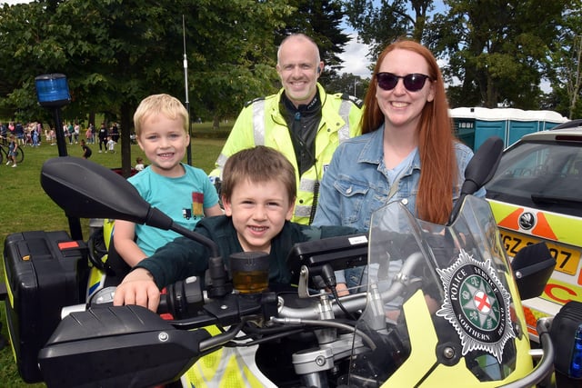 The local PSNI Neighbourhood Policing Team motorbike was a bigg attraction at the fun day and pictured here are Ezra Graham (4) and Matthew Nievuets (4) with Alexis Nievuets and PSNI Sgt Brian Hull. PT32-213.