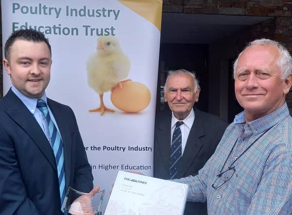 Peter Morgan, Chairman of the Poultry Industry Education Trust, presents the annual Poultry Industry Education Trust award, a Times Atlas of the World and inscribed memento to Wilson McLeister from Portglenone. Looking on is Basil Bayne, a Fellow of Harper Adams University and PIET Trustee.