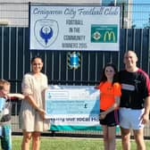 Craigavon man Frank McCabe with his children Michael and Emma handing over a cheque for £3,466 raised through the Angela McCabe Memorial Tournament, a charity soccer tournament held at Craigavon City FC.
