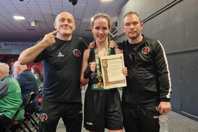 Gilford Amateur Boxing Club's Bernard McComiskey with Lurgan girl Cassie Henderson and trainer Gavin Duffy. Cassie (13)  won the won the 60kg title at the National Junior Cadet Championship in Dublin and is currently in Turkey captaining Team Ireland in the European Championships. She also plays Gaelic for Clann Eireann and soccer for Glentoran.