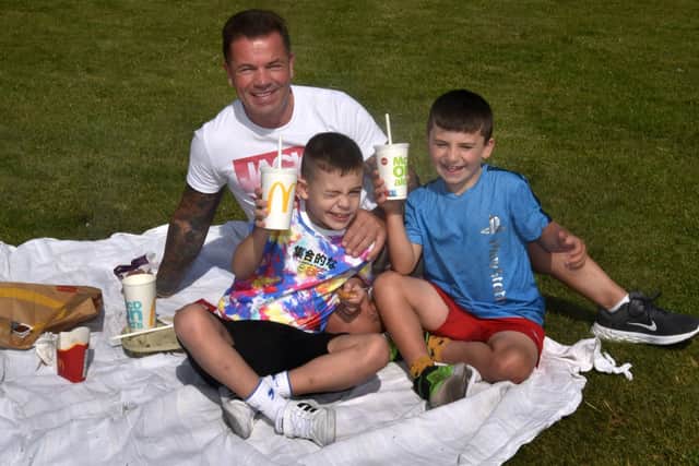 Having a McDonalds picnic at Portadown Pleasure Gardens Park are Elliott Young with son, Milo (7) left, and grandson, Bentley Kelly (7). PT32-230.