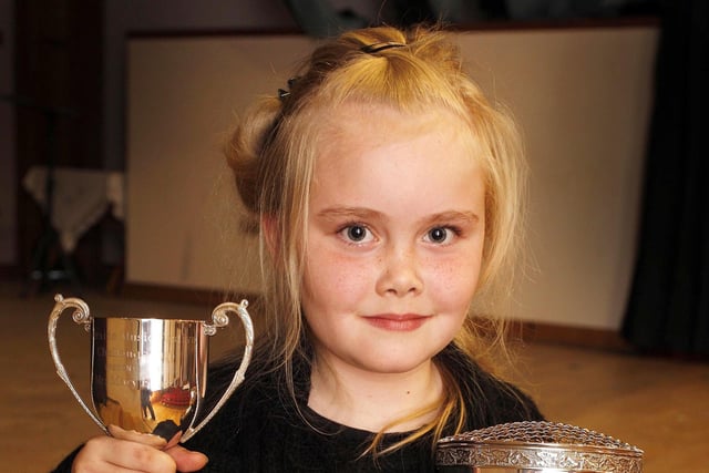 Hannah Glass proudly shows the two cups she won during the Coleraine Music Festival in April 2010