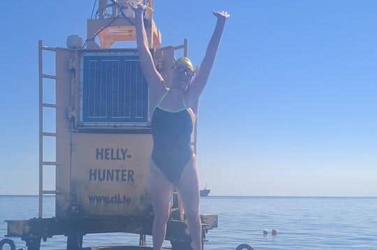 A delighted Jessika celebrates finishing her incredible open water swim, at the Helly Hunter buoy