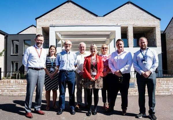 Paul Price (DfC), Loma Wilson (Radius) Prof Roberts (NIHE Chair), Ald Jim Speers, Jessica Brown, Anita Conway (Radius), Cllr Mark Cooper (Housing Council Vice Chair) and  David Polley (DfC) at the new homes.