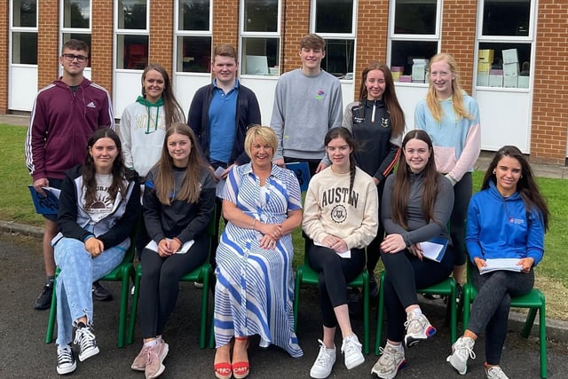 11 of the top achievers at Cross and Passion College  who achieved 34 A*/A grades between them pictured with new principal Mrs Duffy