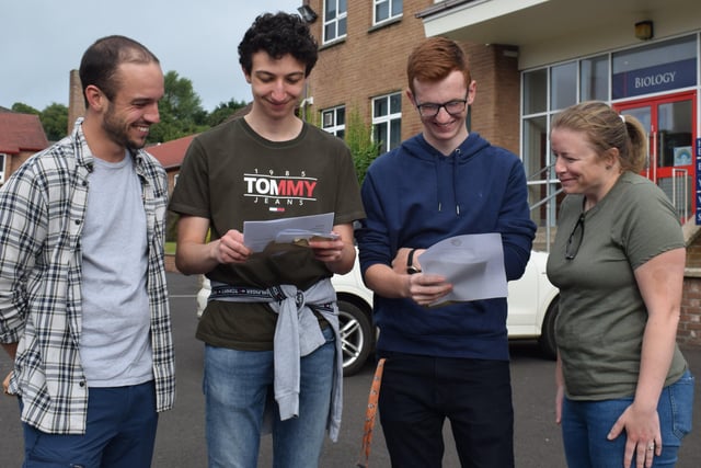 CGS students Christos Pafilis and Ben McClean discuss their results with their teachers