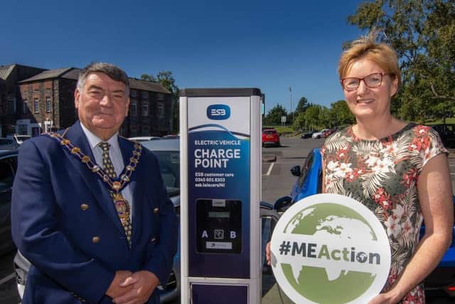 Mayor of Mid and East Antrim, Alderman Noel Williams and Elaine Smith Council's Climate and Sustainability Manager at one of the electric vehicle charge points in Larne.