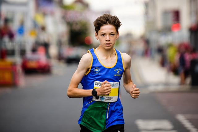 A young Mallusk Harrier running the town centre route.