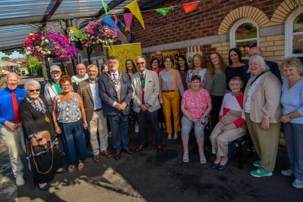 Project participants on the railway platform at Whitehead Railway Museum - one of the project sites - with Mr Mukesh Sharma, Chairman of the Northern Ireland Committee of the National Lottery Fund.