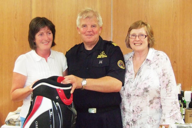 Sean McCarry from the Community Rescue Service presents the first prize to Agatha Mullan on 'Good Cause Day' at Portstewart Golf Club in August 2009.  Also in the picture is Lady Captain Celine Harley
