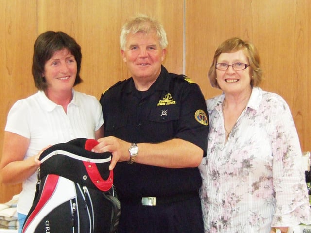 Sean McCarry from the Community Rescue Service presents the first prize to Agatha Mullan on 'Good Cause Day' at Portstewart Golf Club in August 2009.  Also in the picture is Lady Captain Celine Harley