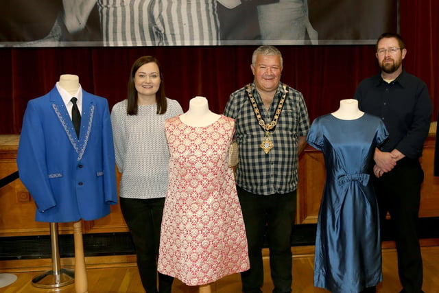 The Mayor of Causeway Coast and Glens Borough Council Councillor Ivor Wallace pictured with Museums Officers Rachel Archibald (left) and Nic Wright (right), with some of the fashion from the dance hall era which is on display in the new exhibition in Coleraine Town Hall