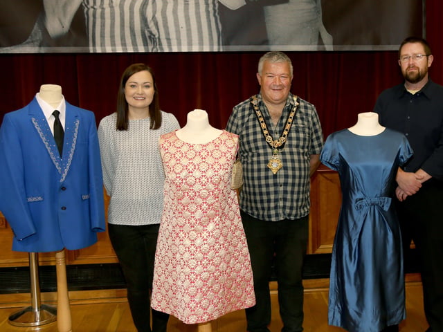 The Mayor of Causeway Coast and Glens Borough Council Councillor Ivor Wallace pictured with Museums Officers Rachel Archibald (left) and Nic Wright (right), with some of the fashion from the dance hall era which is on display in the new exhibition in Coleraine Town Hall