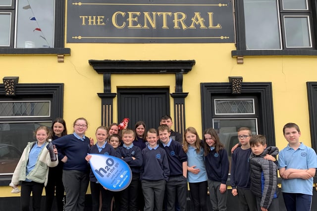 Pupils from Carhill Integrated Primary School pictured outside The Central Bar in Garvagh which has signed up to Causeway Coast and Glens Borough Council’s H20 On The Go scheme