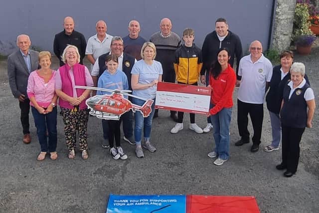 Representatives from the community who raised £12,085 in memory of Maggie Black for Air Ambulance NI