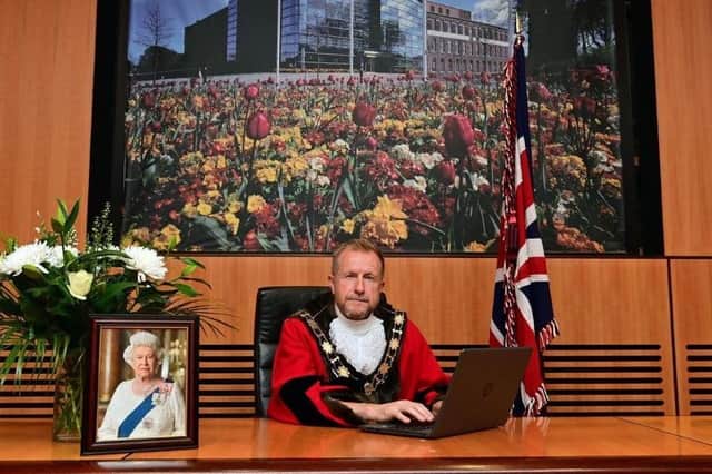 Mayor of Antrim and Newtownabbey, Ald Stephen Ross signing the online book of condolence.