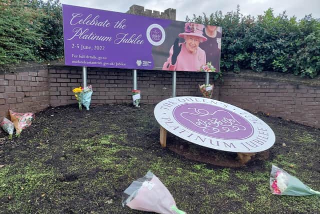 Flowers close to Carrick Castle earlier on Friday before the council issued a request for people to pay tribute at War Memorials.