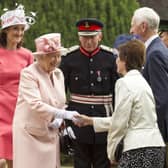 Queen Elizabeth II meets guests during a garden party held at Hillsborough Castle on day two of their visit on June 24, 2014 in Belfast, Northern Ireland. The Royal party are visiting Northern Ireland for three days. (Photo by Liam McBurney - Pool/Getty Images)