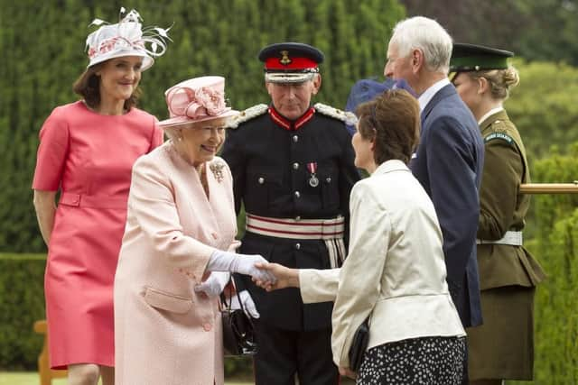 Queen Elizabeth II meets guests during a garden party held at Hillsborough Castle on day two of their visit on June 24, 2014 in Belfast, Northern Ireland. The Royal party are visiting Northern Ireland for three days. (Photo by Liam McBurney - Pool/Getty Images)