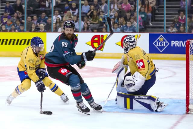 Belfast Giants' Ciaran Long #89 with HC Davos' Sandro Aeschlimann #29 at the SSE Arena, Belfast. Picture by Darren Kidd/Presseye