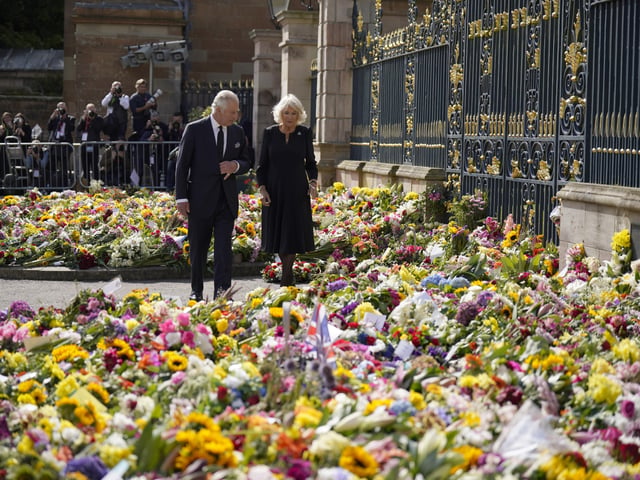 King Charles III and the Queen Consort view floral tributes left outside Hillsborough Castle, Co Down, following the death Queen Elizabeth II on Thursday. Picture date: Tuesday September 13, 2022.