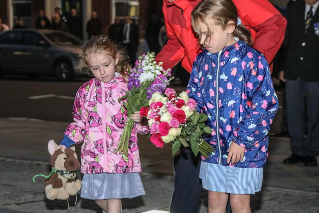 These young girls laid flowers in Remembrance of Queen Elizabeth II. Pic by Norman Briggs, rnbphotographyni