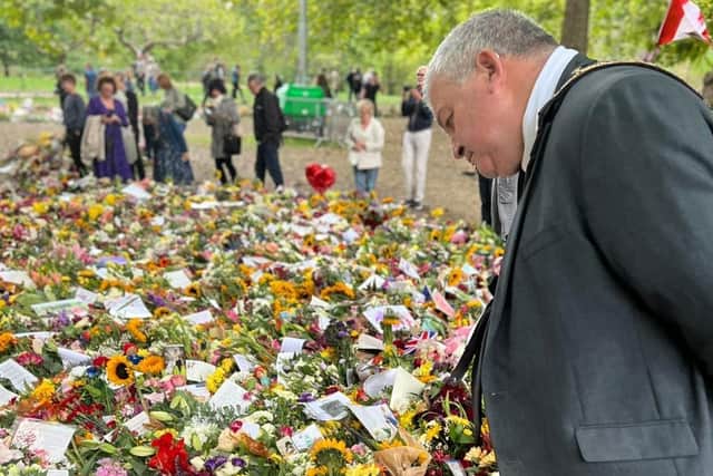 The Mayor of Causeway Coast and Glens Borough Council, Councillor Ivor Wallace, views some of the floral tributes during his trip to London
