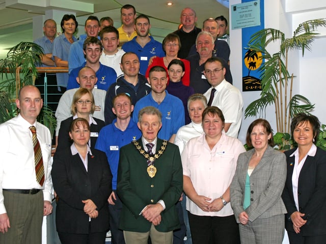 Mayor of Ballymena, Cllr. Maurice Mills, with staff from the Seven Towers Leisure Centre at a special lunch to mark their achievement in the recent Quest Assessment. BT52-214AC