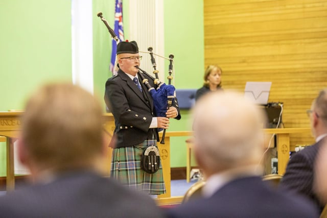 A piper adds to the poignancy of the occasion at Holy Trinity Church.