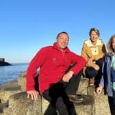 National Trust tour guide Johnnie Little; TV host Samantha Brown; and Ruth Moran, Tourism Ireland, during filming at the Giant's Causeway for the PBS travel show Samantha Brown's Places to Love