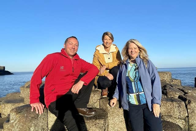 National Trust tour guide Johnnie Little; TV host Samantha Brown; and Ruth Moran, Tourism Ireland, during filming at the Giant's Causeway for the PBS travel show Samantha Brown's Places to Love