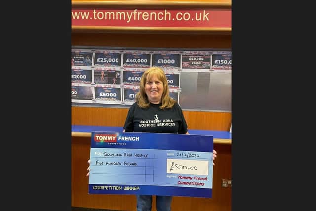 Deirdre Breen from Lurgan, Co Armagh picks up a cheque for £500 on behalf of the Southern Area Hospice in Newry. The money was raised as part of a charity draw ran by Tommy French Competitions. Anam Cara also received £500 towards their charity.