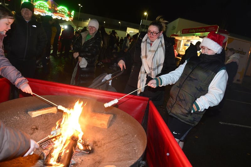 Ronan Diamond getting toasty by the fire pit at the Crumlin celebrations.