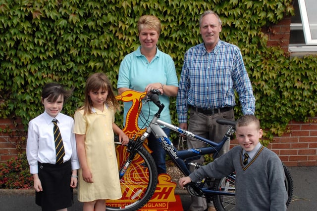 Ronnie McCabrey of McCabrey Cycles presents a Raleigh bike for the Friends of Kings Park summer raffle in 2007 to committee member Elaine Bell and pupils Lauran Constable, Chloe Taylor and Mathew Irwin.