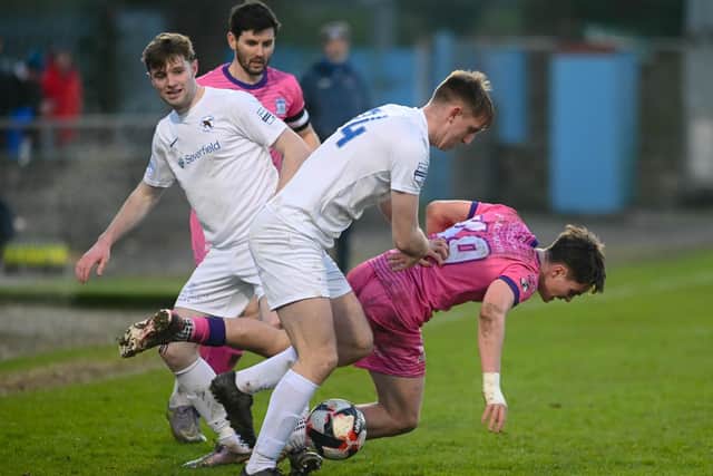 Newry attacker Paul McGovern is pushed to the ground by Ballinamallard's Peter Maguire on Saturday BM2402402