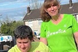 Jessica Conway pictured with Tristan. Jessica is planning to run 12 hours to raise funds to buy Tristan a new wheelchair so he can come with her on training runs. Credit: Submitted