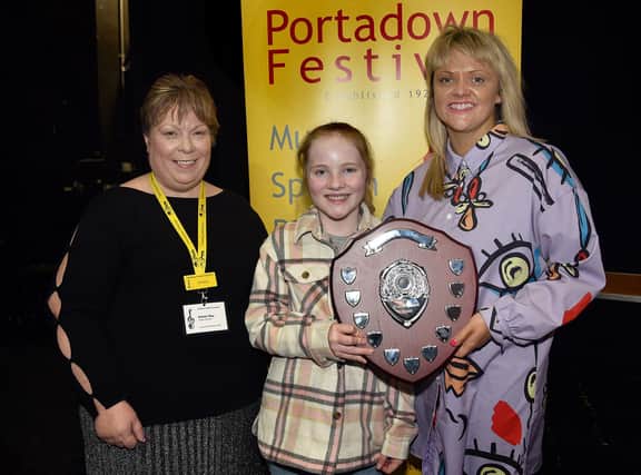 Emily Robinson is presented with the Evelyn Cooper Memorial Shield for Two Performances Of Excellence 9-11 Years, by Pamela Cassells, right who donated the new trophy. Also included is Speech Festival secretary, Karen Hoy. PT10-234.
