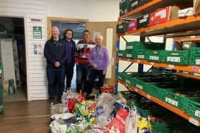 Lisburn Foodbank take stock as over 200kg of food was donated on the day of the Trust Christmas quiz. Pic credit: SEHSCT