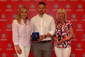 The family of the late Stephen Barr (daughter Stephanie, son Jason and wife Cindy) receiving the clasp for Stephen’s 30 years of service.