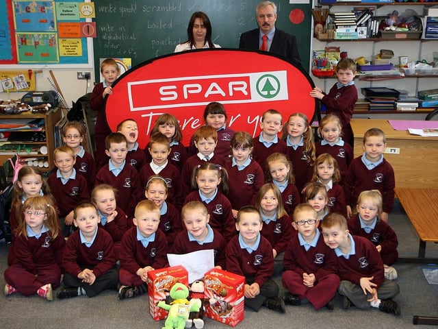 Largymore Primary School pupils Ann Ferris and Jade Mullan pictured with their Easter eggs which they won in the Saintfield Road Spar Easter colouring in competition in 2009. Also pictured are their classmates who also entered the competition.