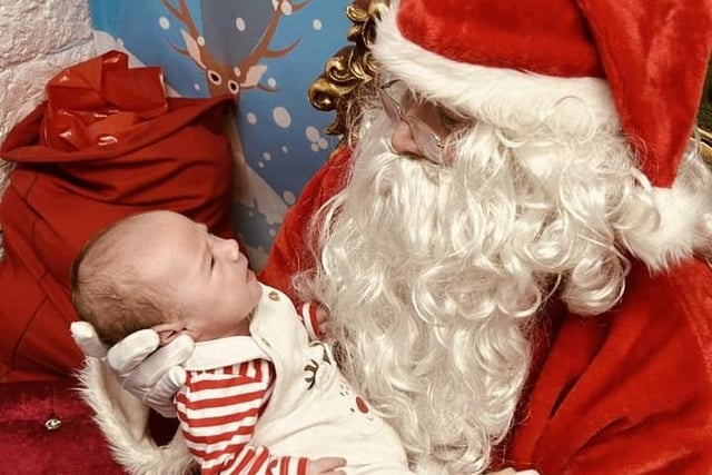 This little one meets Santa for the first time.