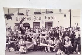 John Weatherup (seventh from left, back row, with his right hand raised under a supporter's flag) with fans and Irish Cup final-suited Carrick Rangers players and staff before setting off from the town for the 1995 game against Linfield. Photo: National World