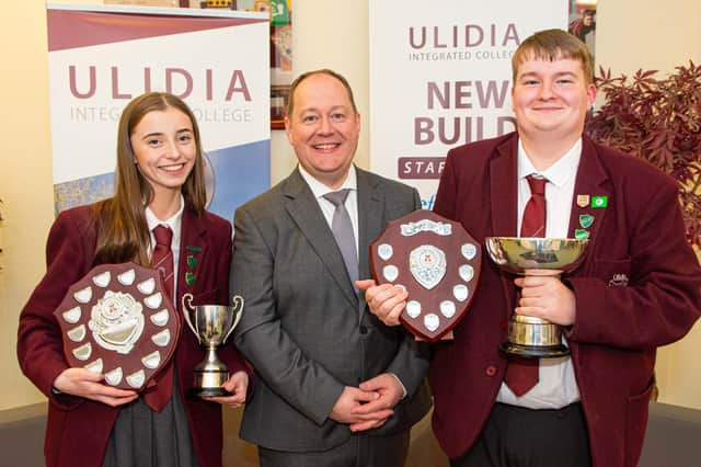 Mr Houston with Katie Adams (current head girl) awarded the Attendance Shield and Matthew McMullan (current head boy) awarded the Principal’s Trophy and the Community Shield.