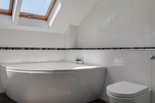 En-suite bathroom with  corner panel bath.