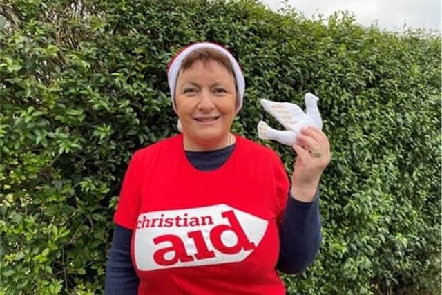Jenny Farlow, who gives her time to help run The Changing Room, Christian Aid’s charity shop in Garvagh, is hanging a dove of peace on her Christmas tree this festive season in solidarity with all those whose lives have been devastated by war. CREDIT CHRISTIAN AID