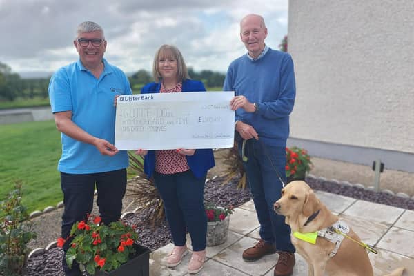 Finvoy woman Donna Dempsey presents a cheque for £2500 to Gary Wilson, Guide Dogs NI Community Fundraising Relationship Manager, and Guide dog owner Ian Mathew and Guide Dog Mac. Credit Guide Dogs NI
