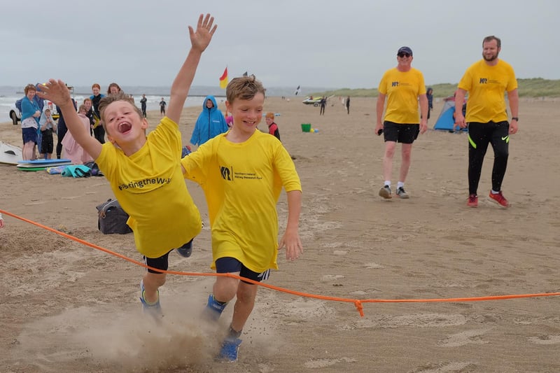 10-year-old twins Micah, diving across the line, and Jonah Daffurn finish their 40 mile run over six days on Castlerock Beach. The boys were raising money for Northern Ireland Kidney Research Fund in memory of their aunt Dr Jennifer McCaughan.