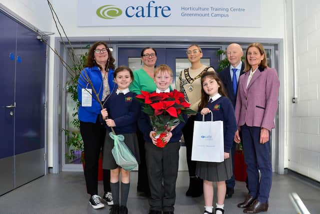 Deputy Mayor of Antrim and Newtownabbey, Cllr Leah Smyth with Lori Heartman and Dr Eric Long from Cafre and Claire Faulkner from Garden Show Ireland presenting pupils at King’s Park Primary School with an apple tree.